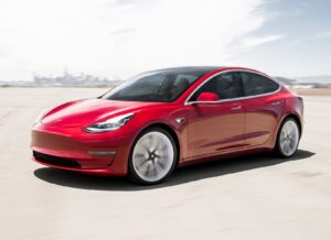 2019 Tesla Model 3: red front quarter, driving